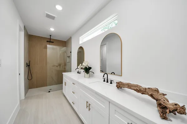 a spacious bathroom with a double vanity sink and a mirror