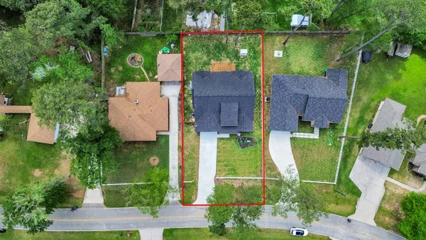 an aerial view of a house with a garden and outdoor seating