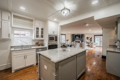 a kitchen with sink stove and refrigerator