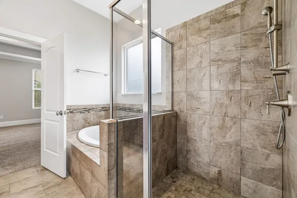 a bathroom with a granite countertop shower and a sink