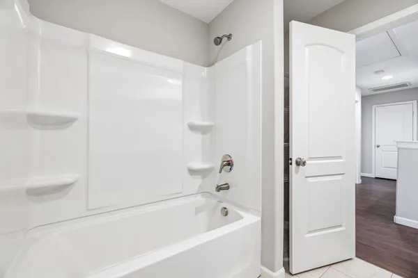 a bathroom with a tub a sink and a shower