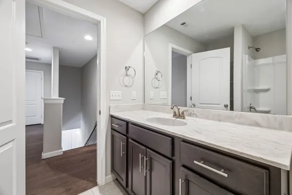 a bathroom with a granite countertop sink and a mirror
