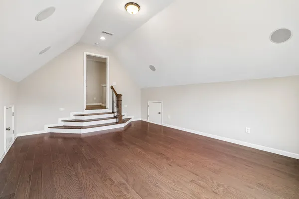 an empty room with wooden floor
