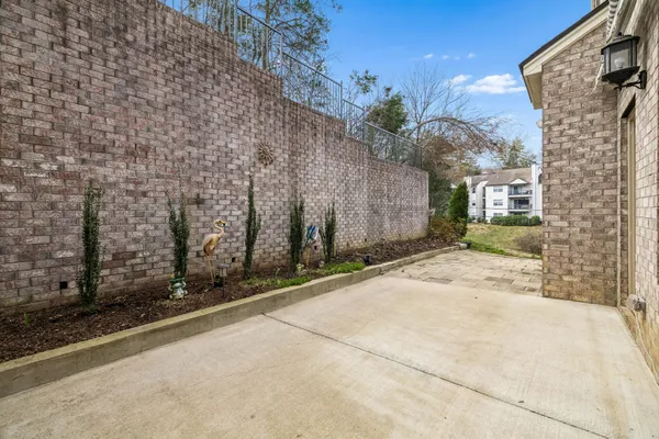 a view of a brick house with a small yard