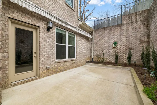 a view of a brick house with a large windows