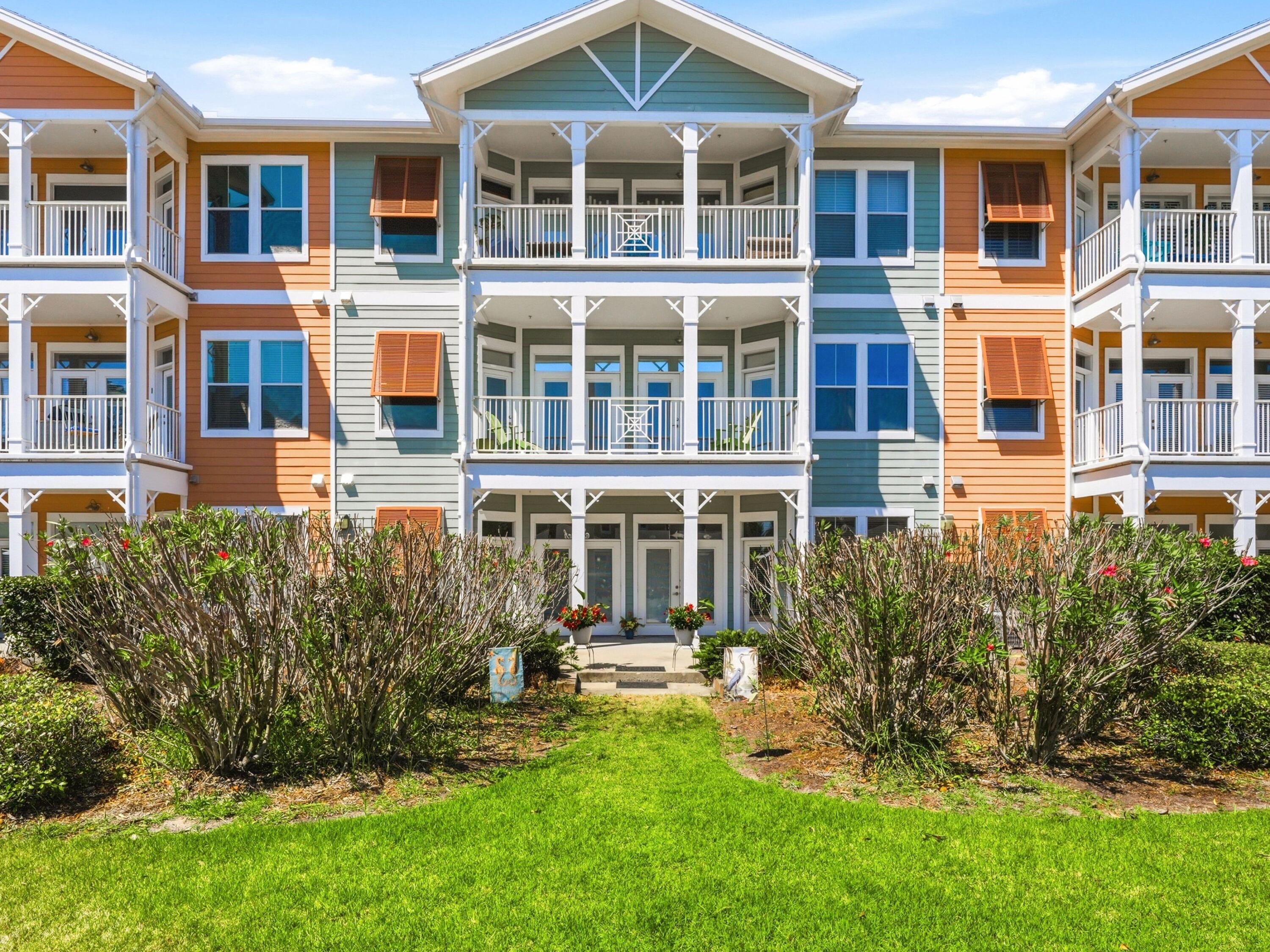 8700 Front Beach Road, Unit 7107 Panama City Beach, FL 32407 - Photo 1 of 54 a view of a brick building next to a yard