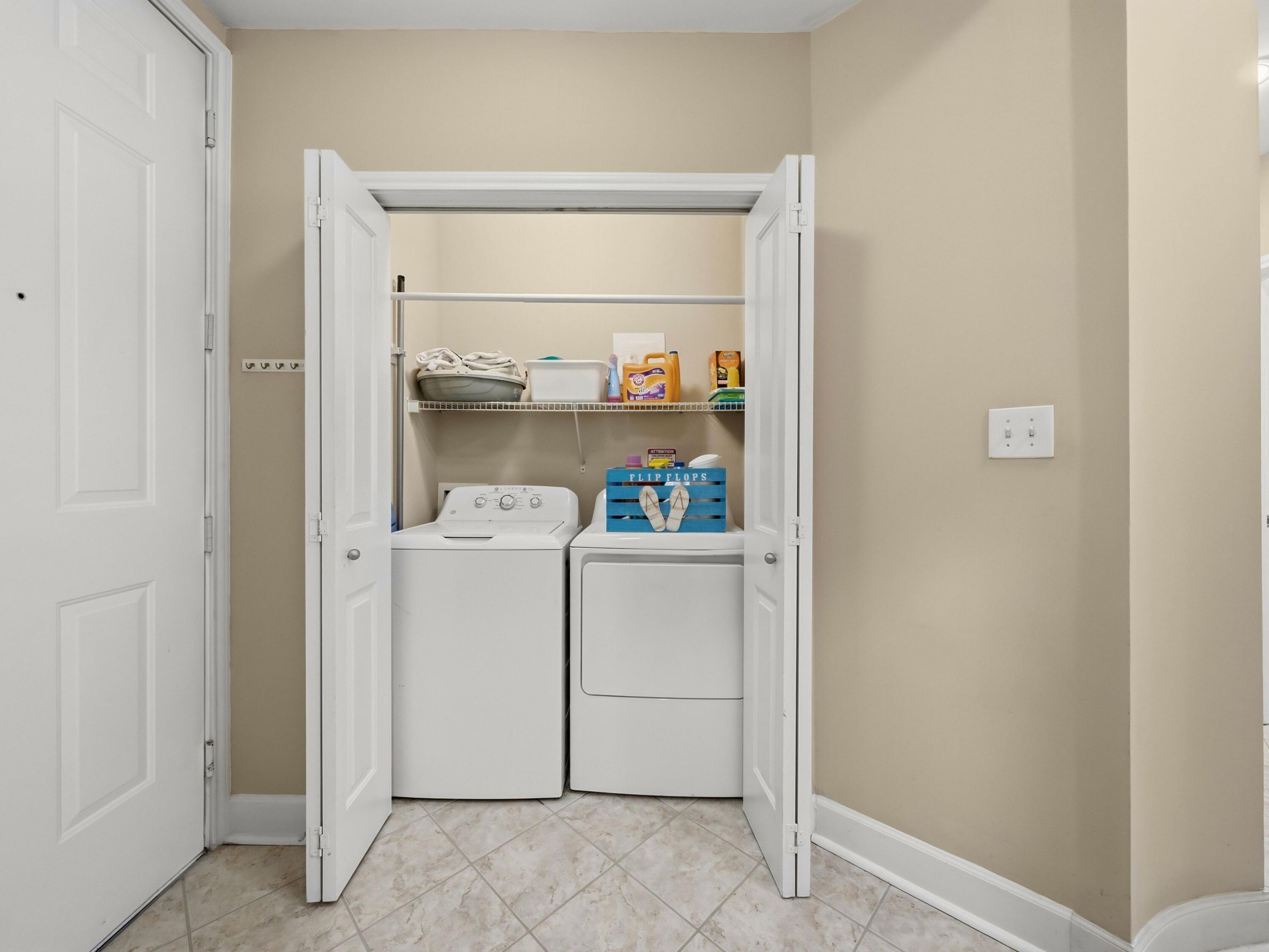 8700 Front Beach Road, Unit 7107 Panama City Beach, FL 32407 - Photo 11 of 54 a utility room with dryer and washer