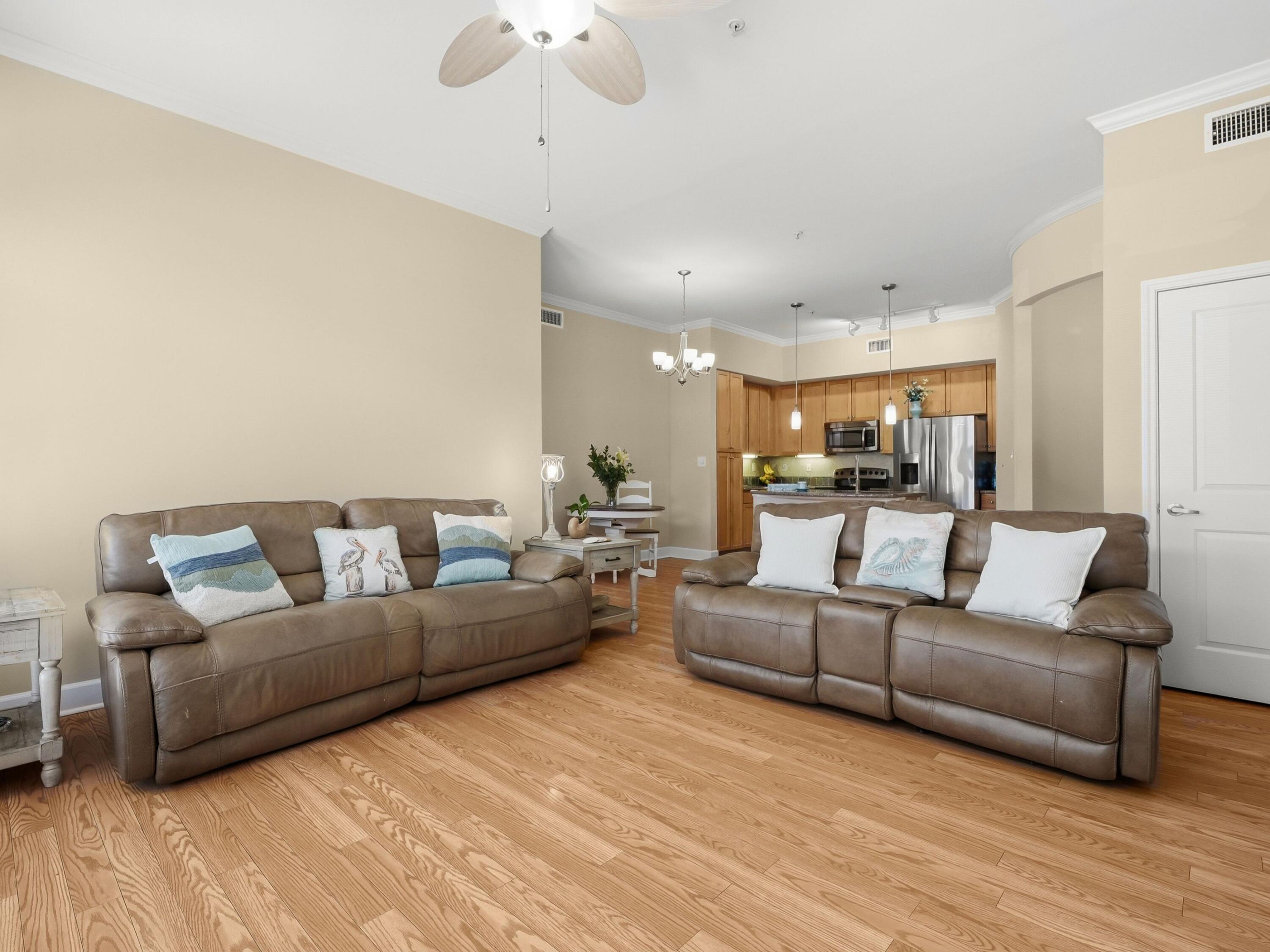 8700 Front Beach Road, Unit 7107 Panama City Beach, FL 32407 - Photo 13 of 54 a living room with furniture and a wooden floor