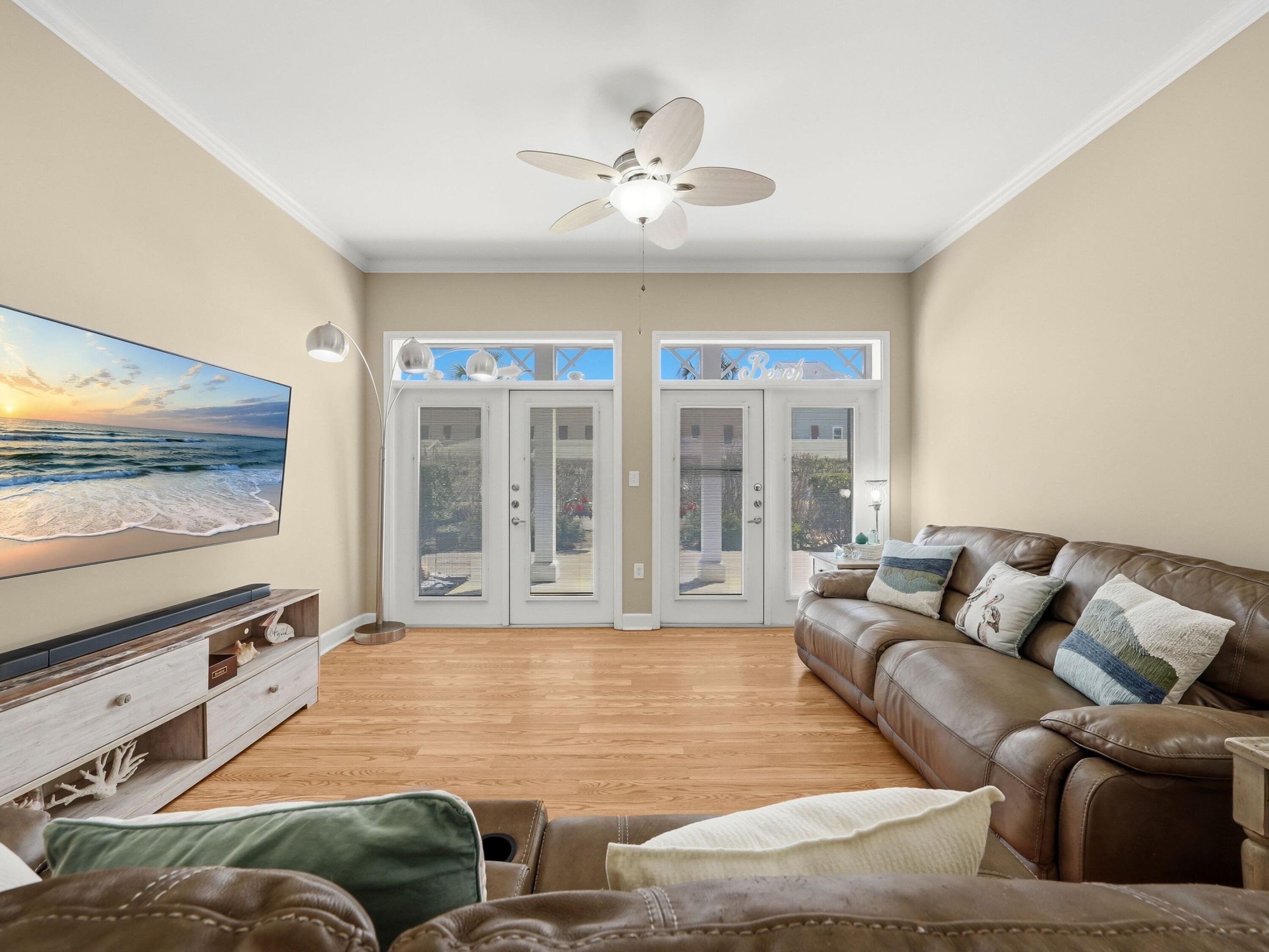 8700 Front Beach Road, Unit 7107 Panama City Beach, FL 32407 - Photo 14 of 54 a living room with furniture flat screen tv and a large window
