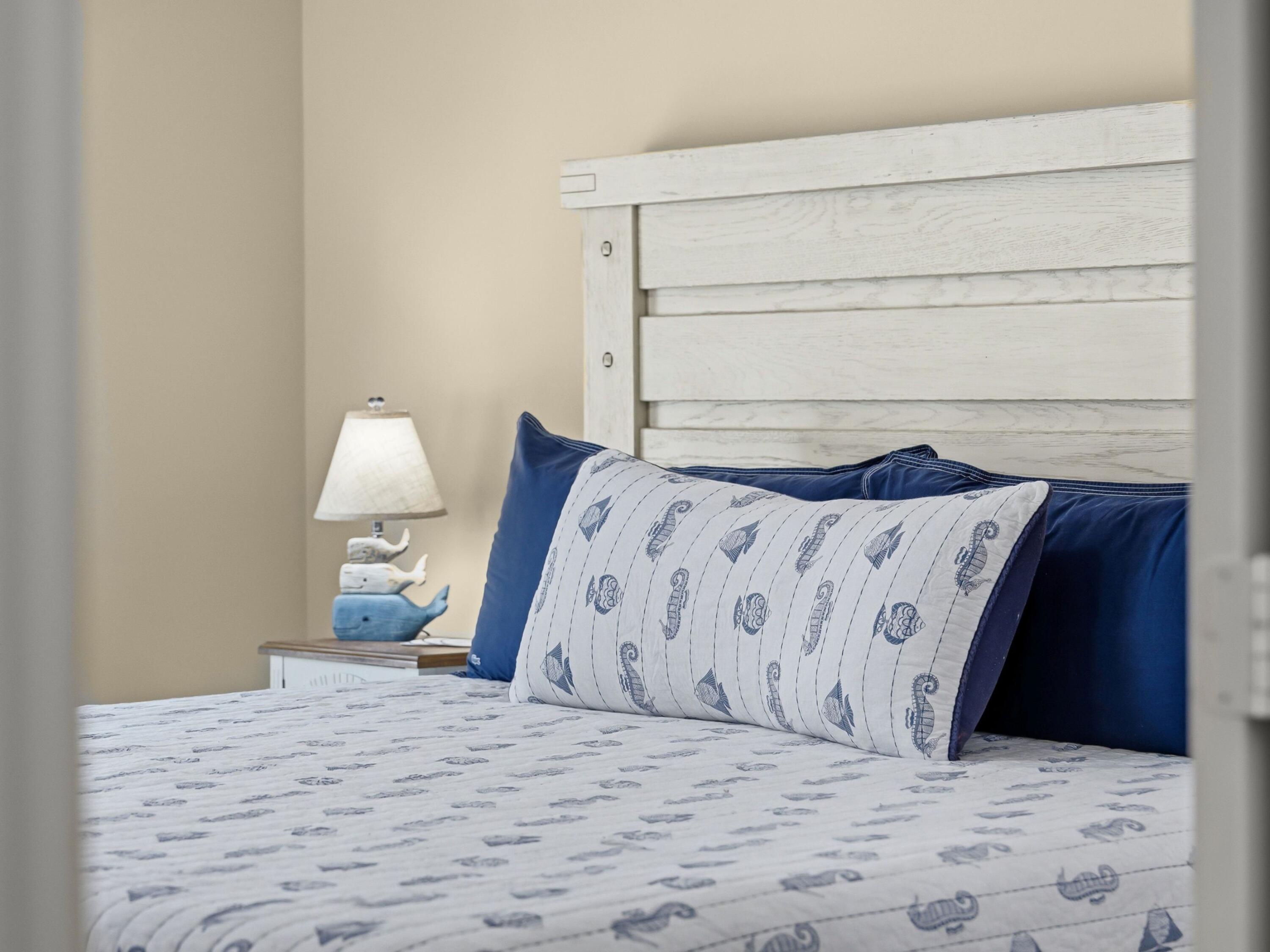 8700 Front Beach Road, Unit 7107 Panama City Beach, FL 32407 - Photo 22 of 54 a bedroom with a bed and a lamp on dresser