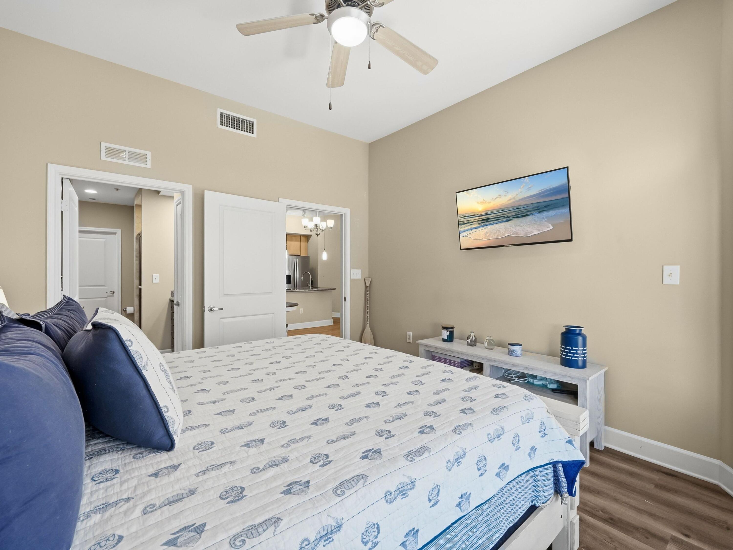 8700 Front Beach Road, Unit 7107 Panama City Beach, FL 32407 - Photo 23 of 54 a bedroom with a bed and a chandelier