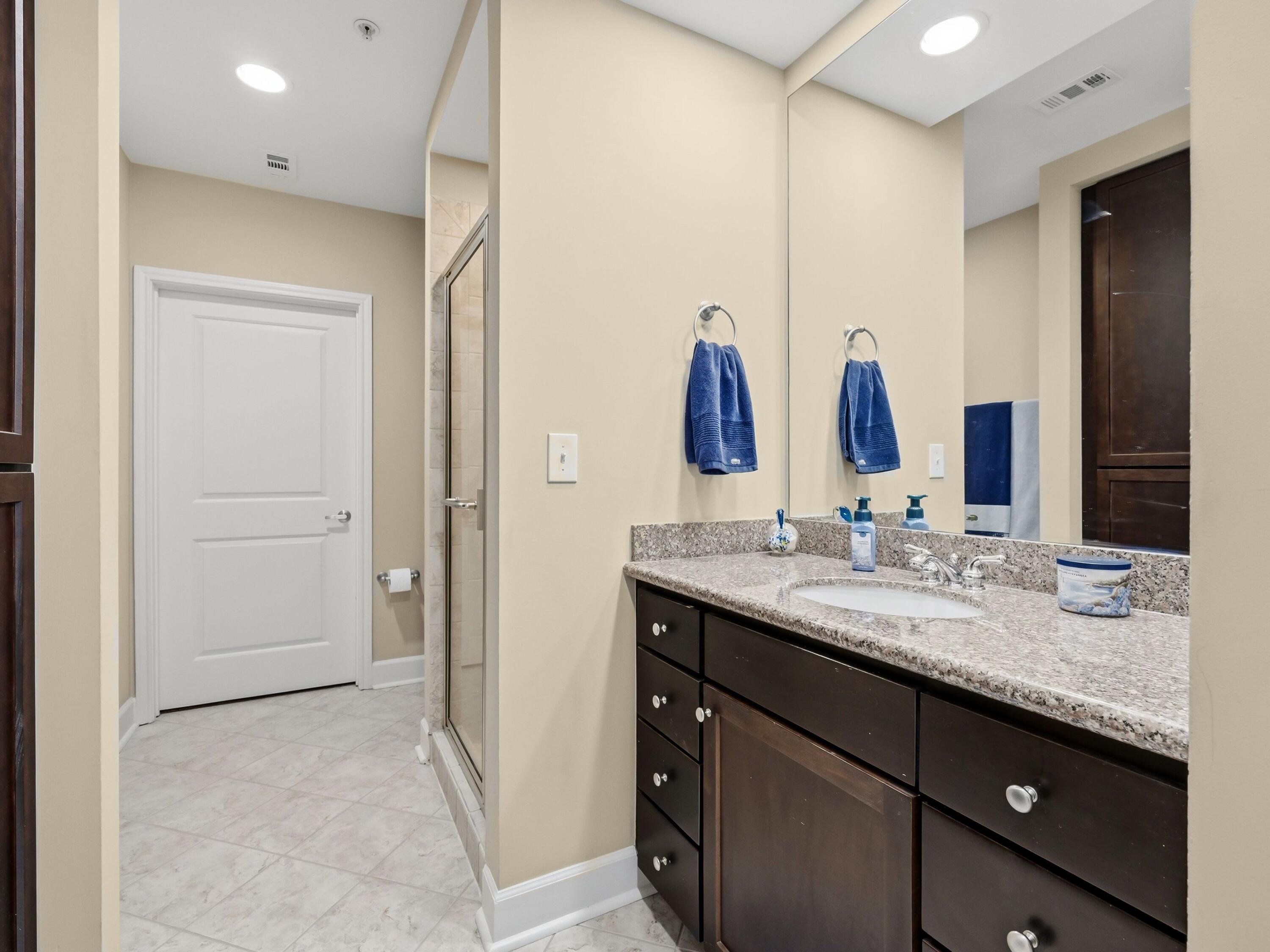 8700 Front Beach Road, Unit 7107 Panama City Beach, FL 32407 - Photo 24 of 54 a bathroom with a granite countertop sink and a mirror