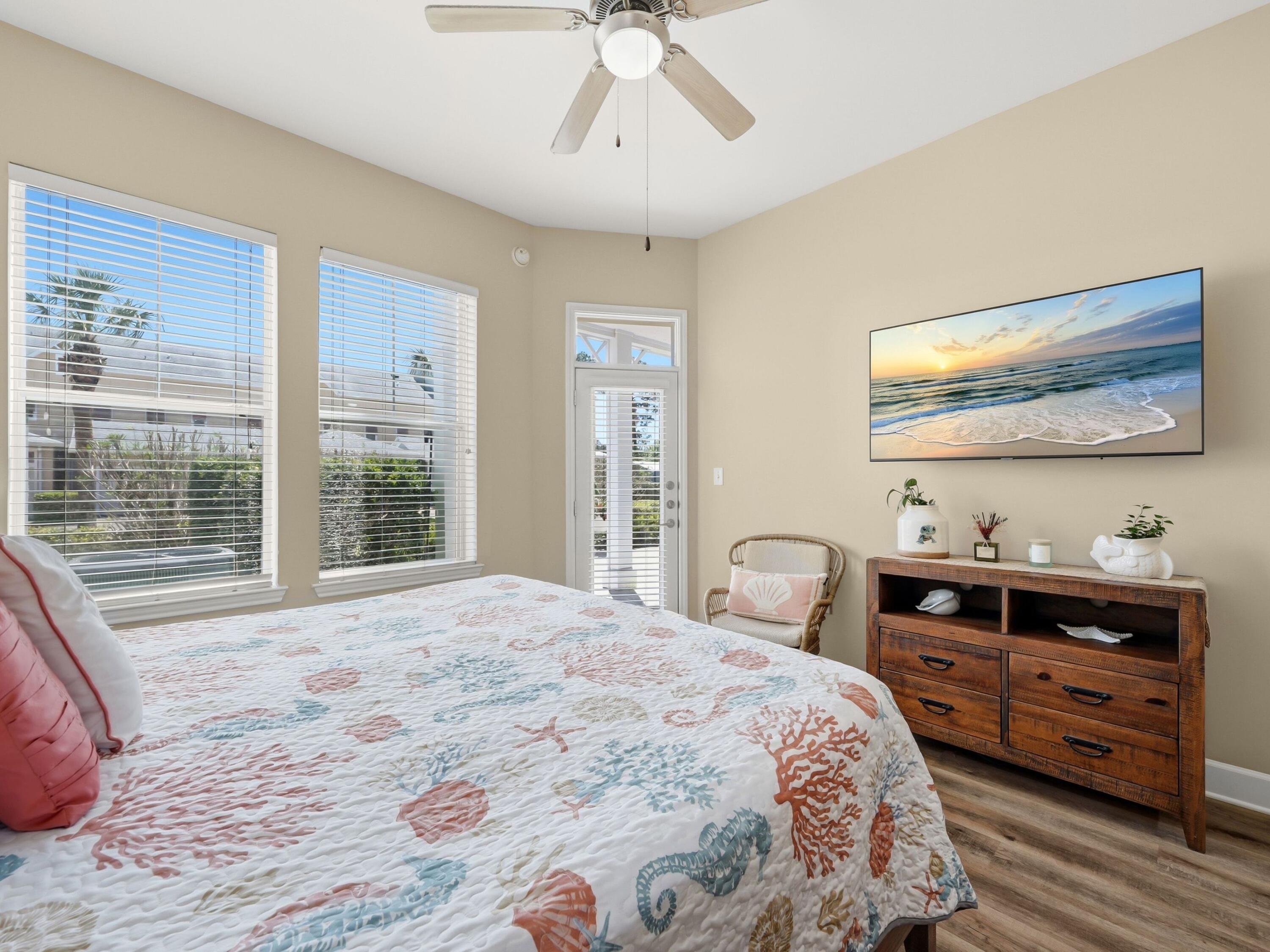 8700 Front Beach Road, Unit 7107 Panama City Beach, FL 32407 - Photo 31 of 54 a bedroom with a bed and a dresser next to a window