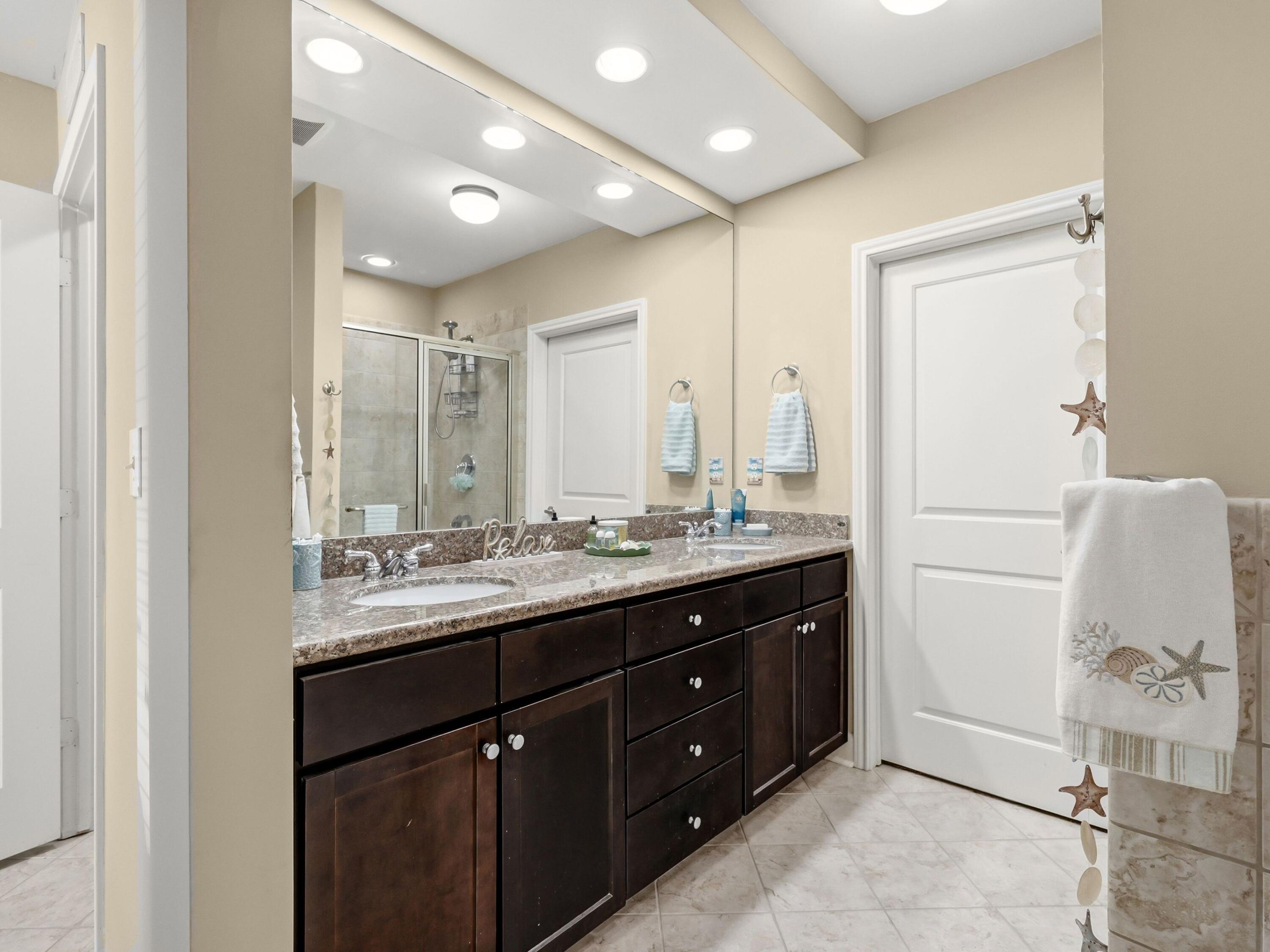 8700 Front Beach Road, Unit 7107 Panama City Beach, FL 32407 - Photo 32 of 54 a bathroom with a double vanity sink and a mirror