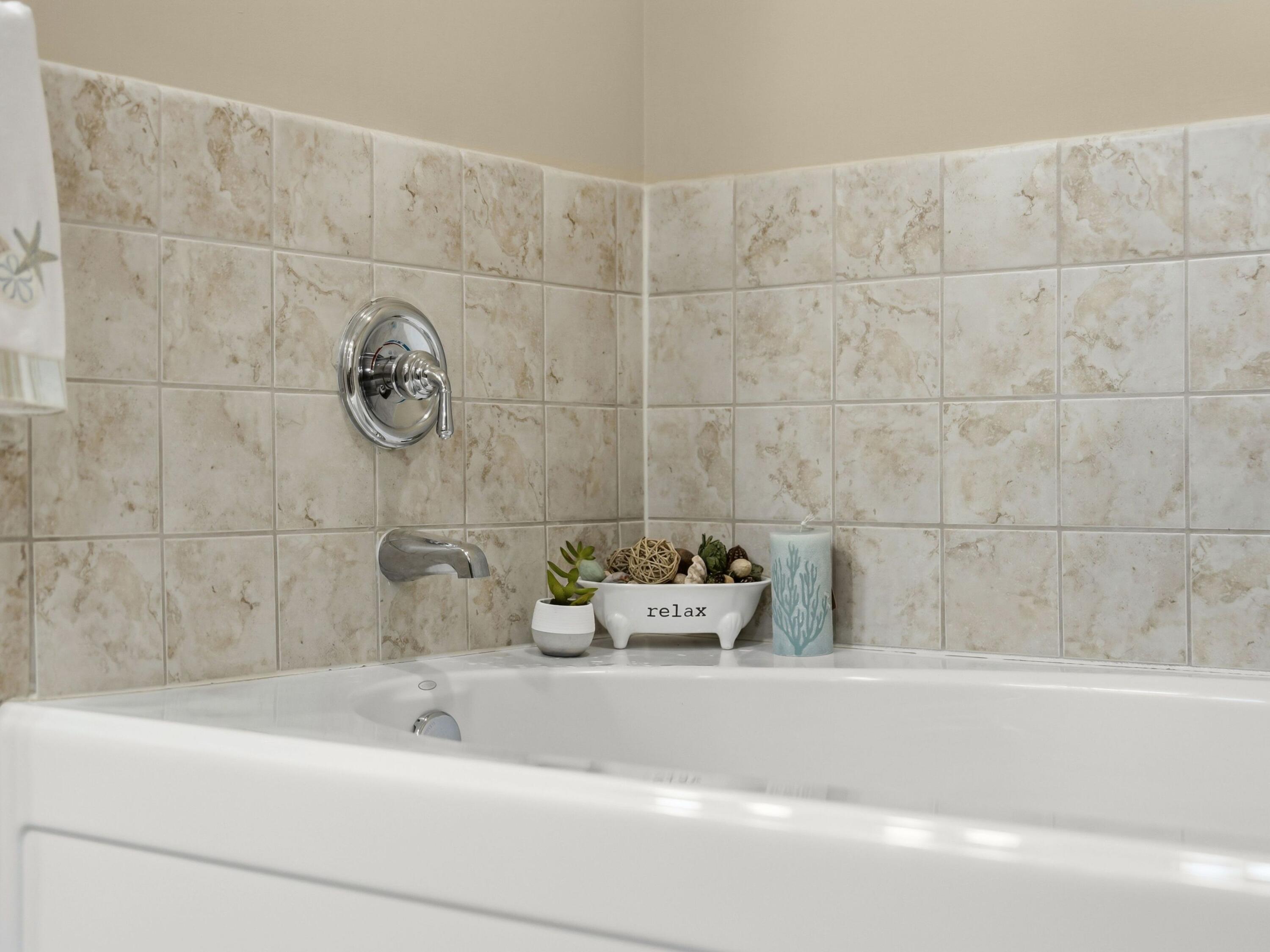 8700 Front Beach Road, Unit 7107 Panama City Beach, FL 32407 - Photo 34 of 54 a bathroom with a bathtub