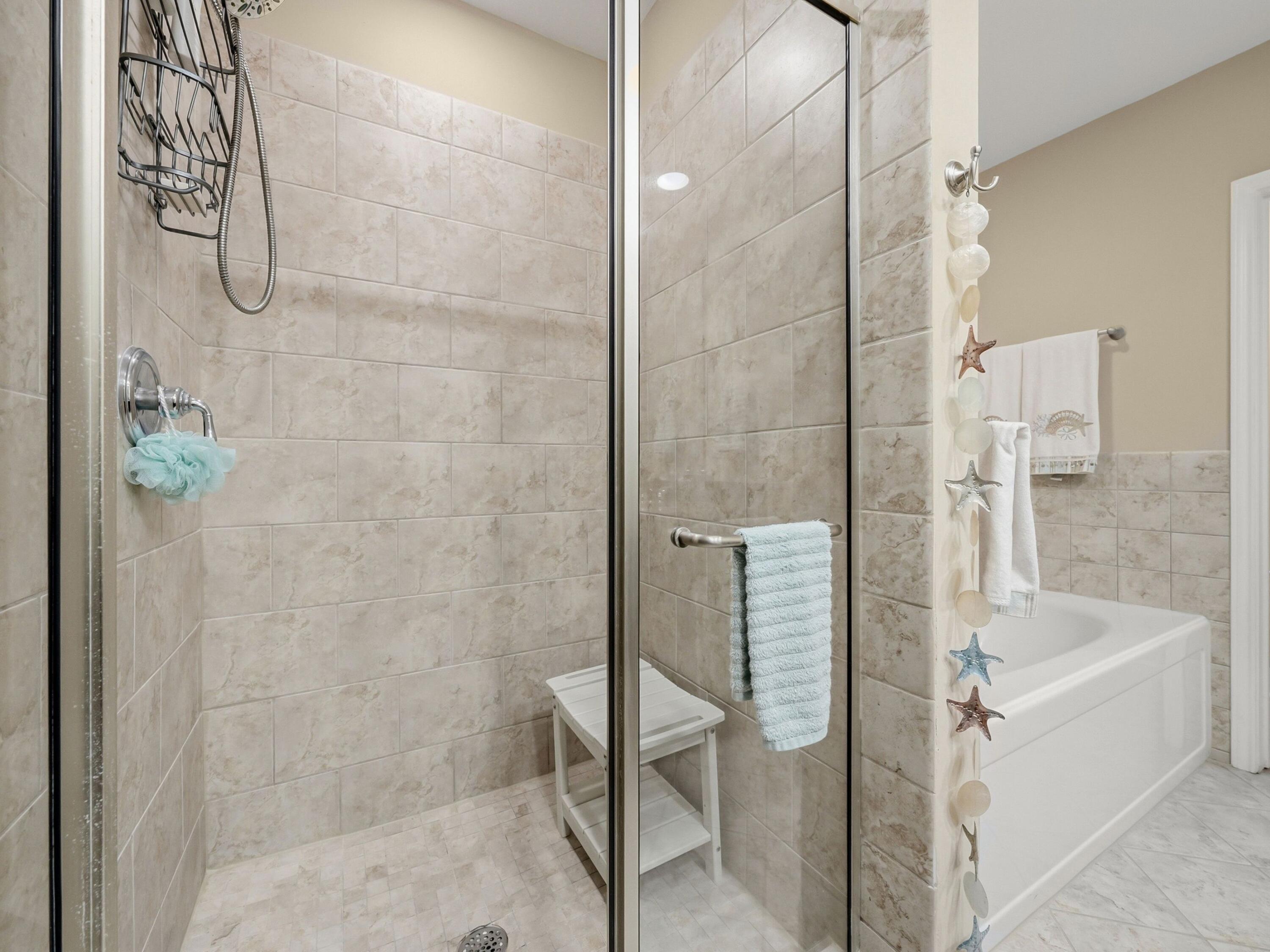 8700 Front Beach Road, Unit 7107 Panama City Beach, FL 32407 - Photo 35 of 54 a bathroom with a bathtub and shower