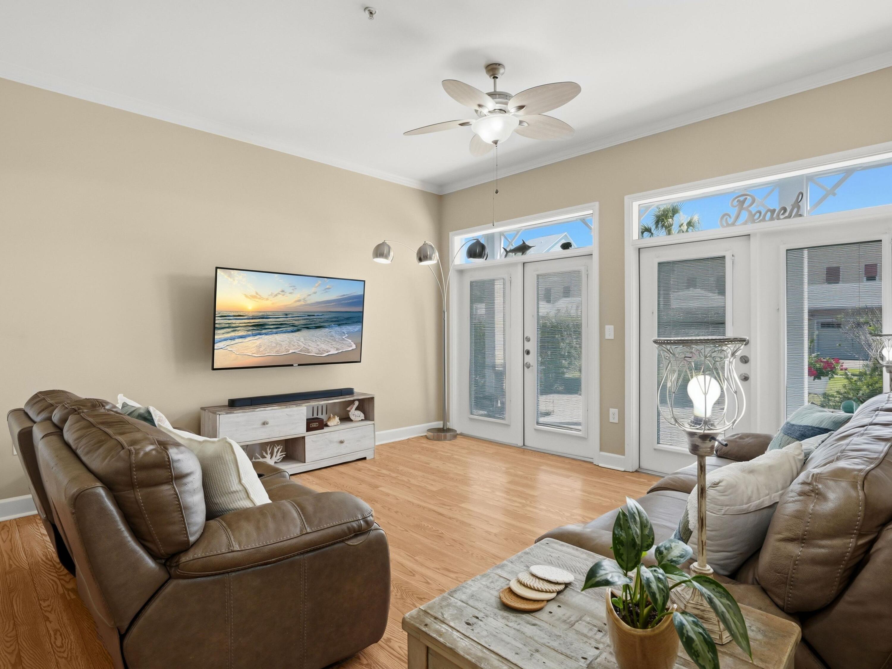 8700 Front Beach Road, Unit 7107 Panama City Beach, FL 32407 - Photo 4 of 54 a living room with furniture and a flat screen tv