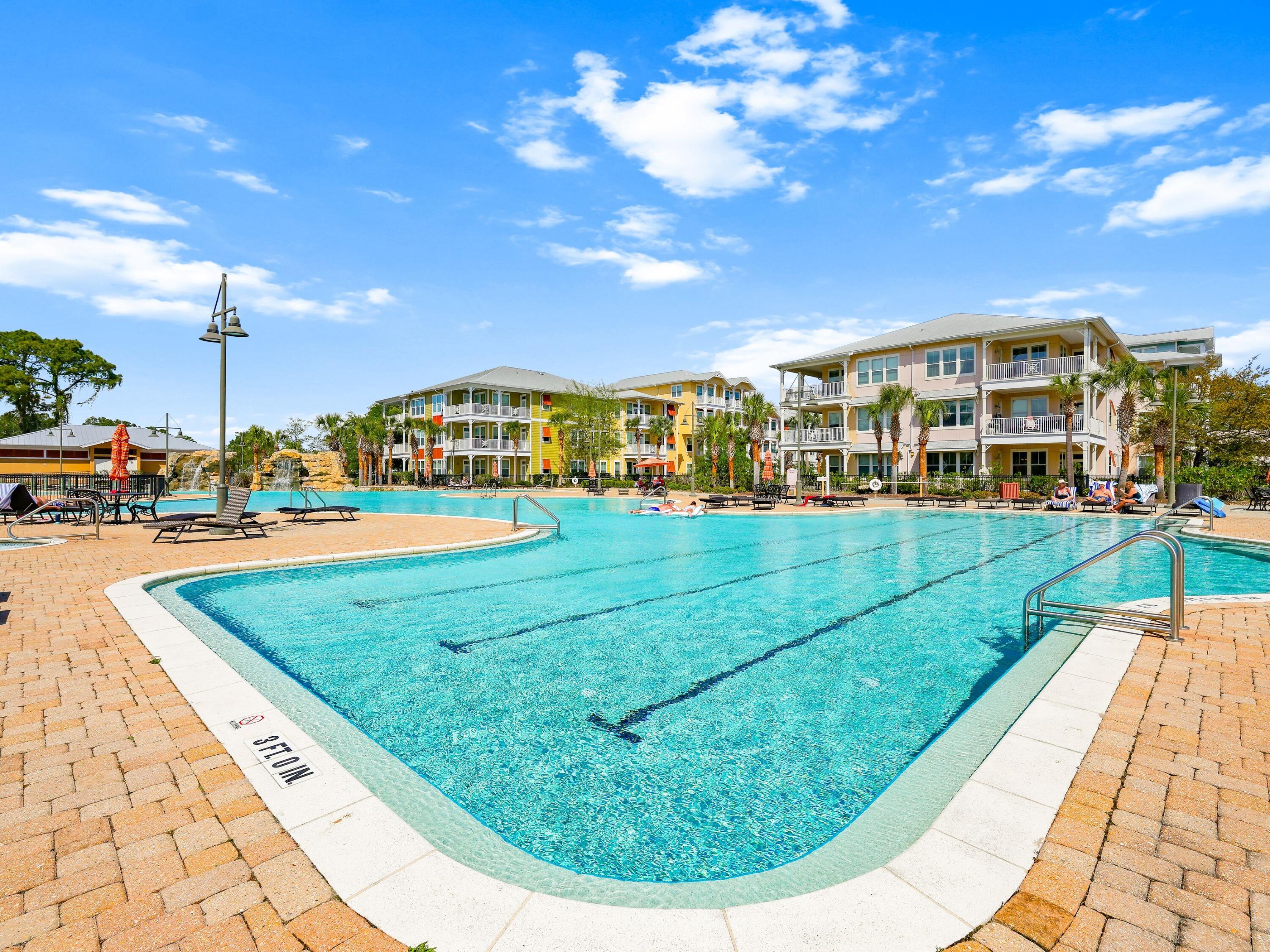 8700 Front Beach Road, Unit 7107 Panama City Beach, FL 32407 - Photo 42 of 54 a view of a swimming pool with a garden