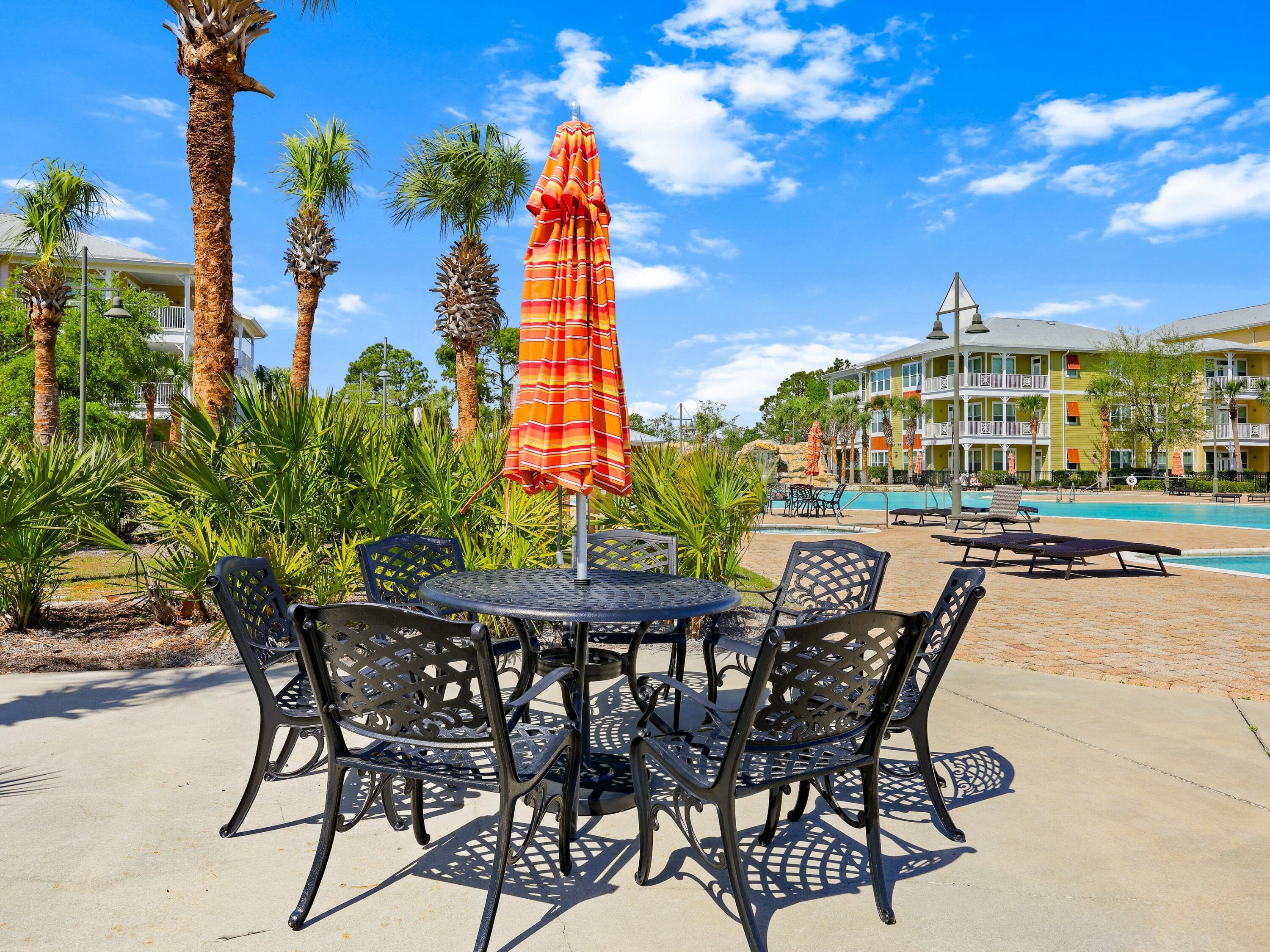 8700 Front Beach Road, Unit 7107 Panama City Beach, FL 32407 - Photo 47 of 54 a view of a chairs and table in a patio