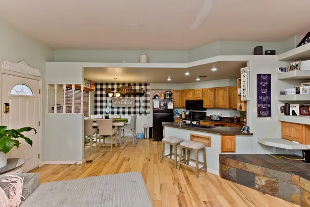 a living room with lots of furniture and kitchen view