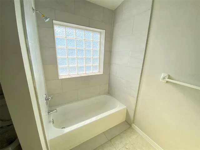 a white bath tub sitting next to a window
