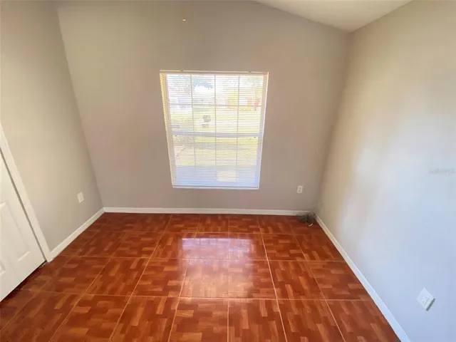 a bedroom with a bed and a rug