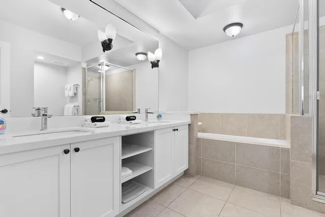 a bathroom with a bathtub a sink and a mirror