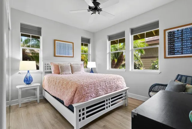 a bedroom with a bed and windows