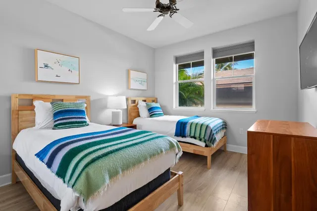 a bedroom with two beds and a window