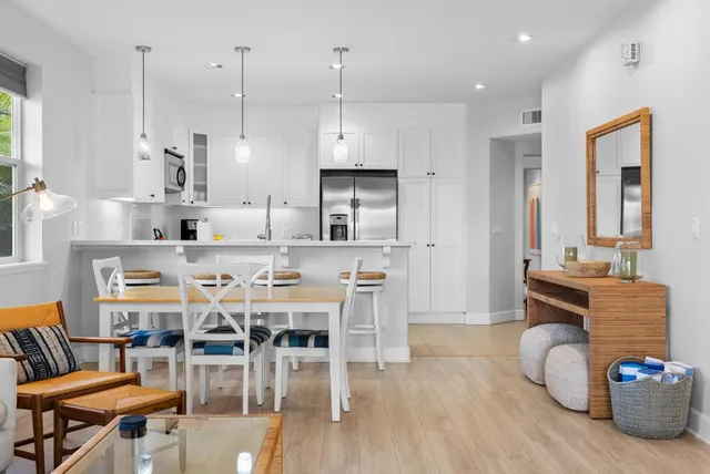 a dining room with furniture a wooden floor and a chandelier