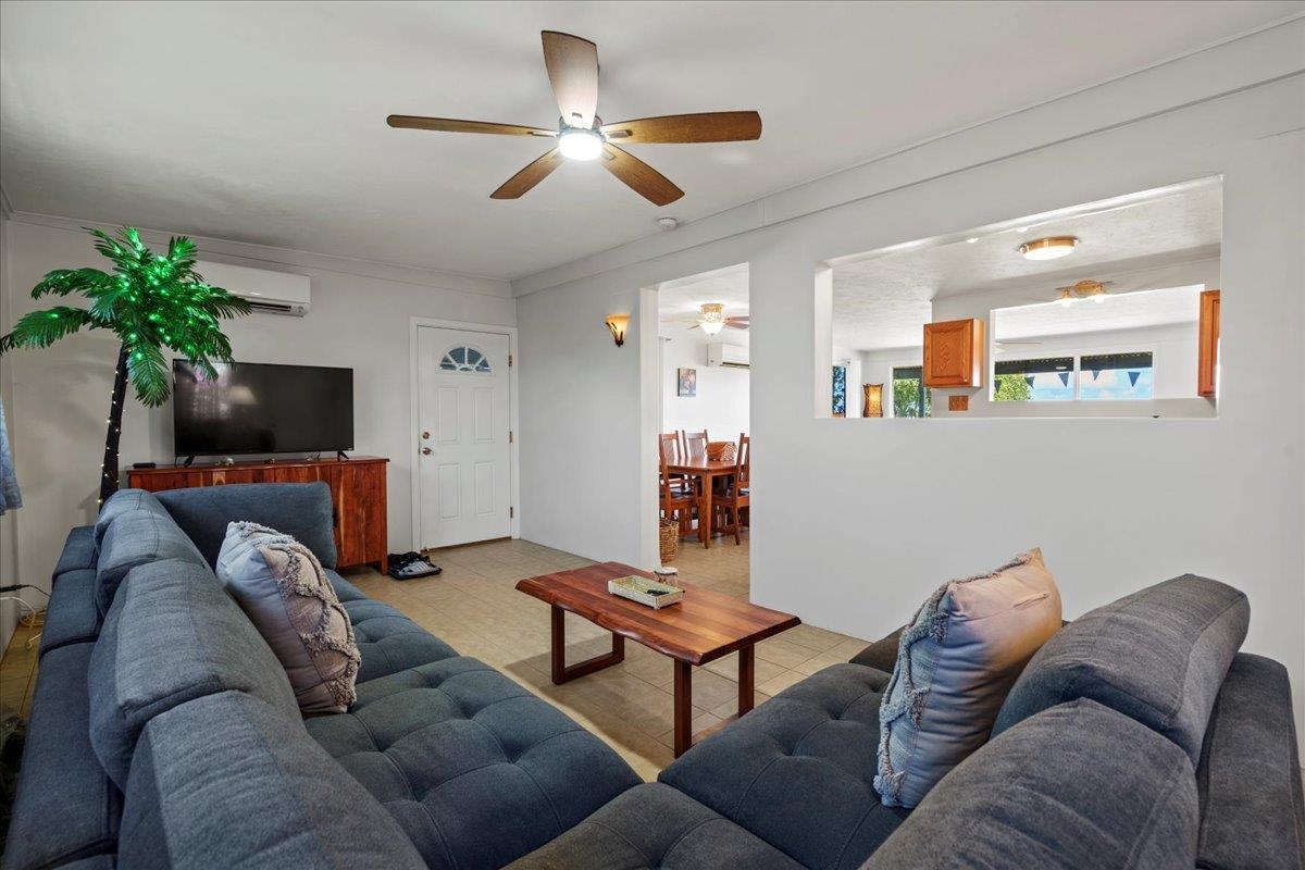 110 Kahiapo Place Haiku, HI 96708 - Photo 14 of 36 a living room with furniture a ceiling fan and a flat screen tv