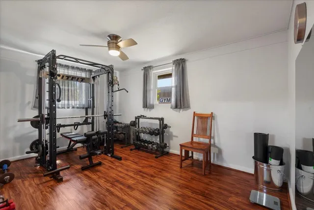 a front view of house with yard and trees in the background