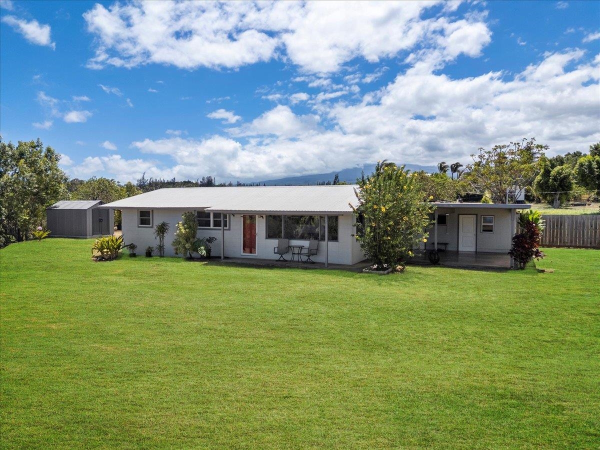 110 Kahiapo Place Haiku, HI 96708 - Photo 20 of 36 a front view of house with yard and trees in the background