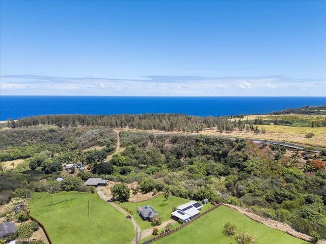 a living room with furniture and a large window with wooden floor