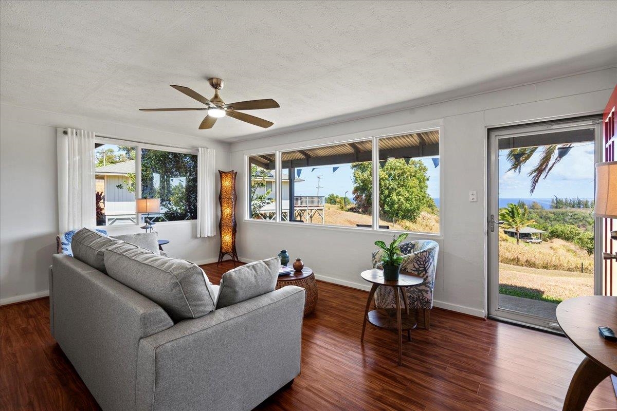 110 Kahiapo Place Haiku, HI 96708 - Photo 4 of 36 a living room with furniture and a large window with wooden floor