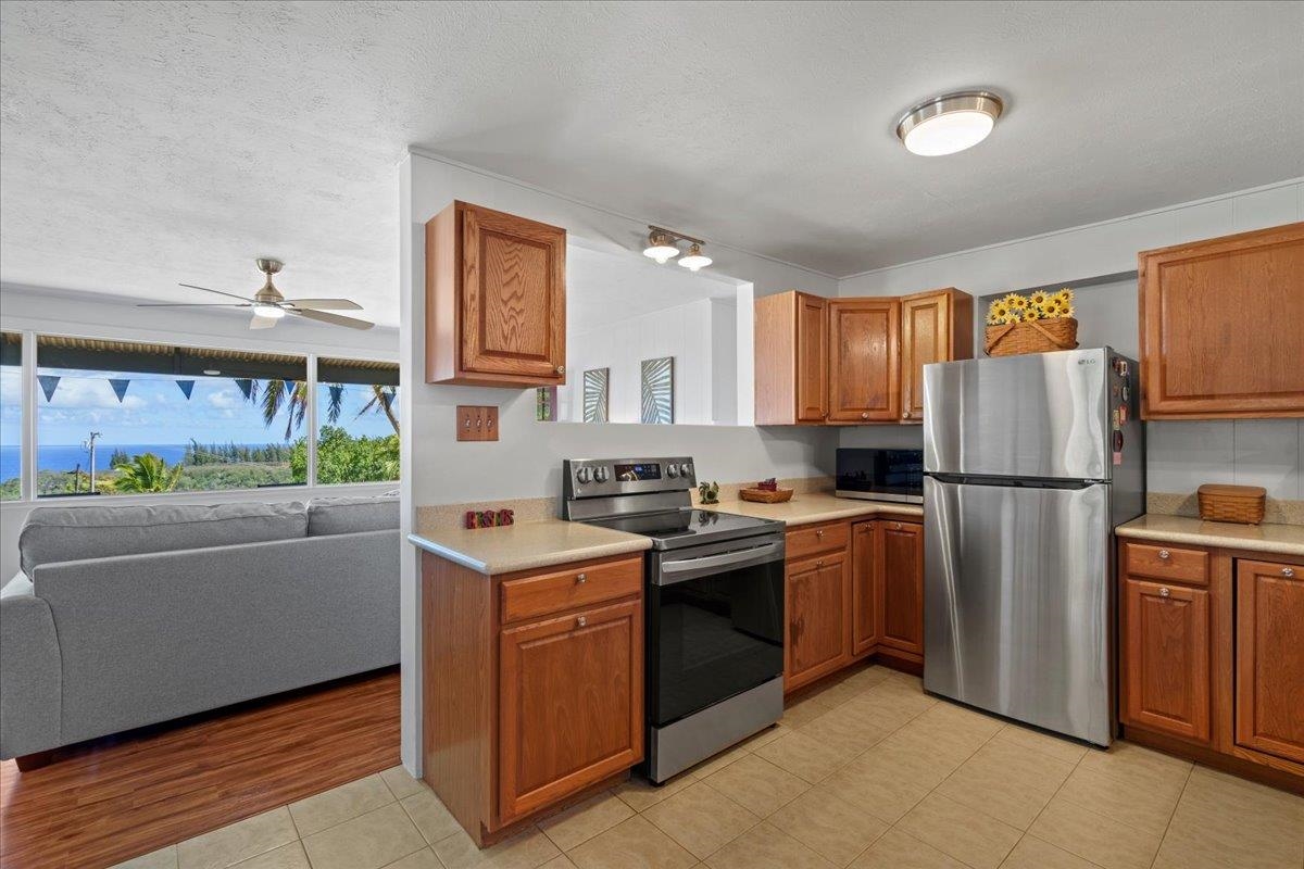 110 Kahiapo Place Haiku, HI 96708 - Photo 9 of 36 a kitchen with stainless steel appliances granite countertop a refrigerator a stove a sink and a refrigerator