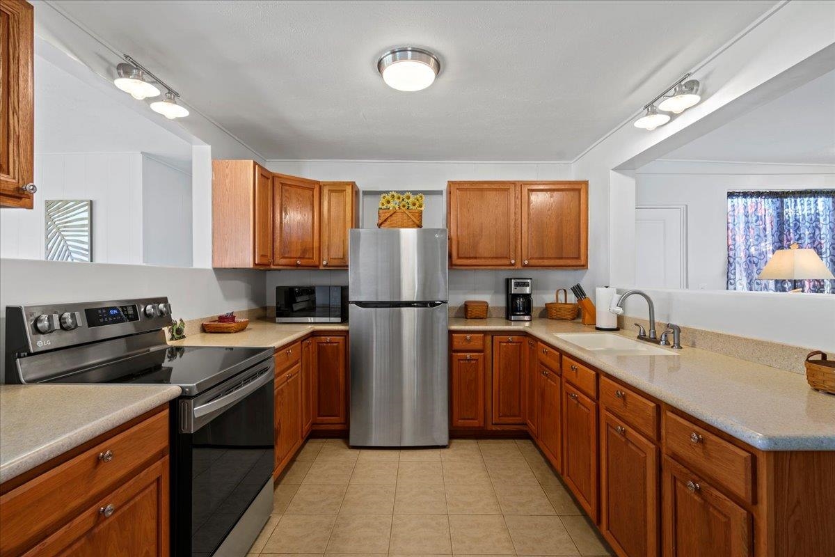 110 Kahiapo Place Haiku, HI 96708 - Photo 10 of 36 a kitchen with stainless steel appliances granite countertop a sink stove microwave and refrigerator