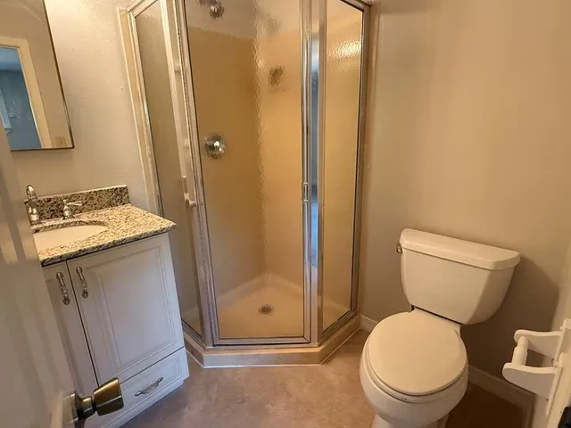 a bathroom with a toilet sink and a mirror
