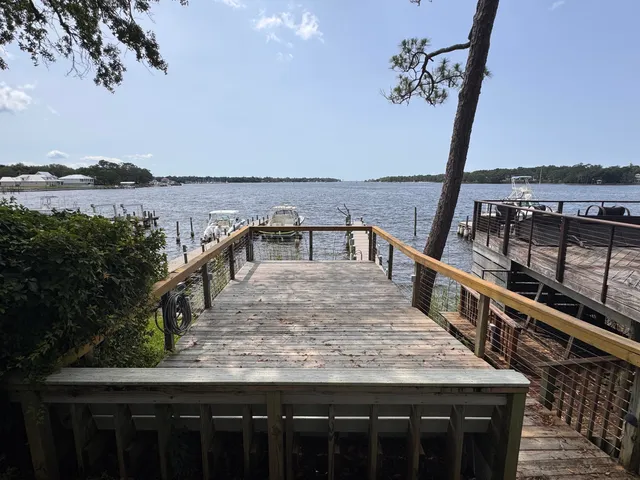 a view of a roof deck with wooden fence and floor
