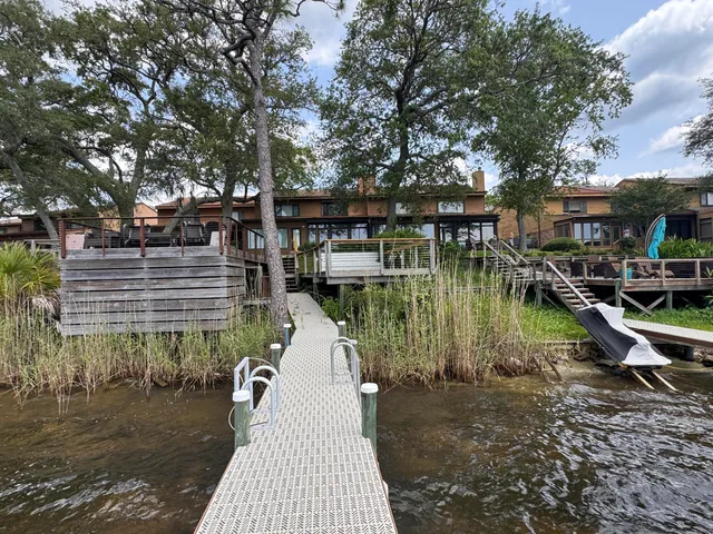 a view of a wooden deck with a lake view