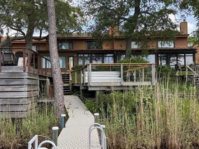 a backyard of a house with lots of green space and fountain