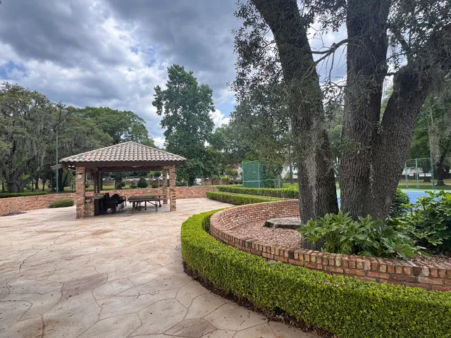 a view of a house with garden and sitting area