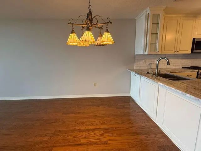 a view of a kitchen with a sink dishwasher microwave and cabinets