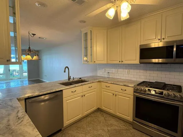 a kitchen with a sink stove and microwave