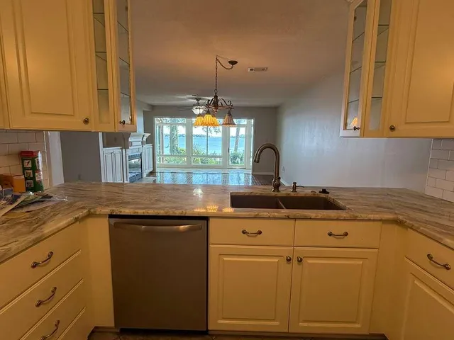 a kitchen with granite countertop cabinets stainless steel appliances and a counter space