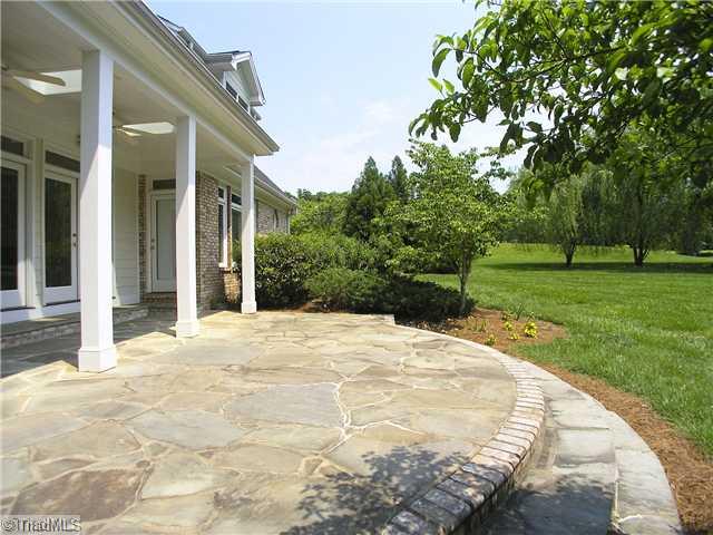 6102 Gwynedd Road Summerfield, NC 27358 - Photo 14 of 16 Patio/Deck. Covered Flagstone Patio Over Looking 2 Acres In A Quiet Neighborhood