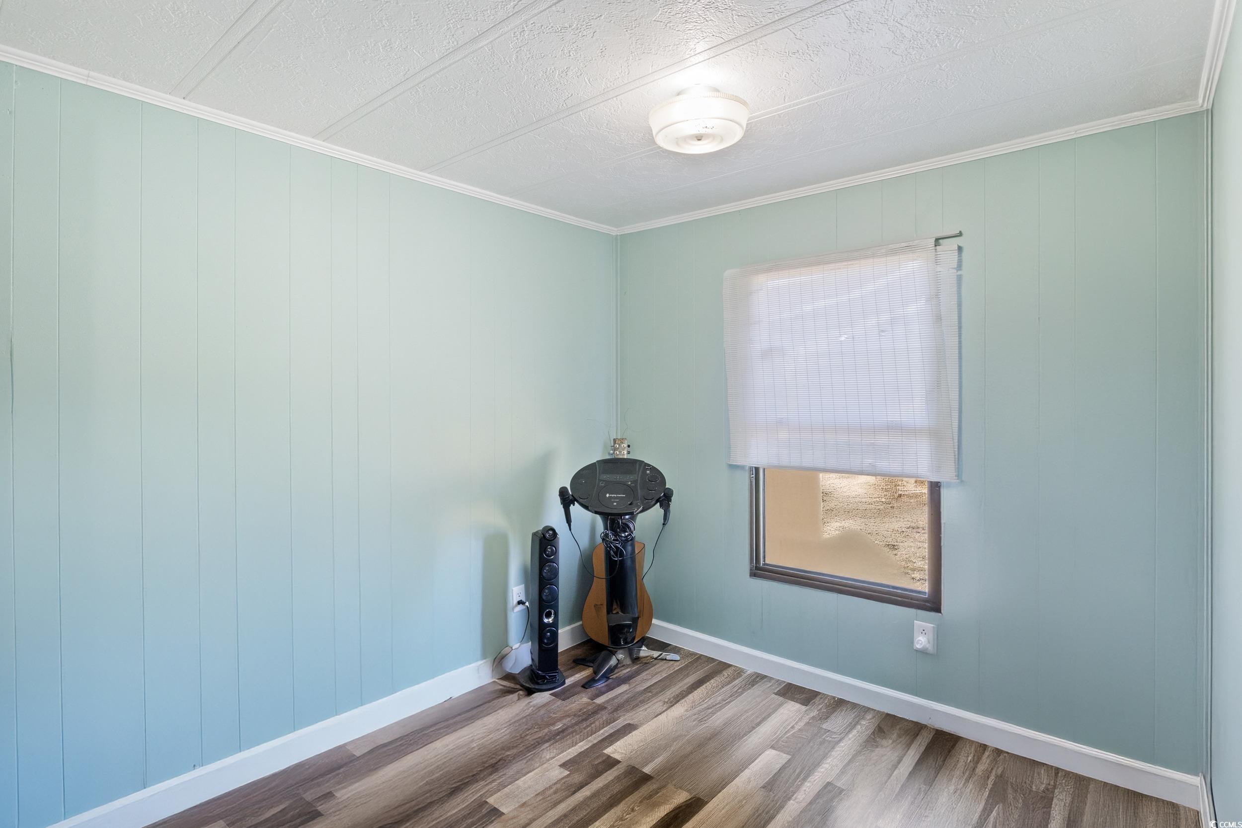 6469 Norton Road Green Sea, SC 29545 - Photo 14 of 25 Empty room featuring wood-type flooring, a texture