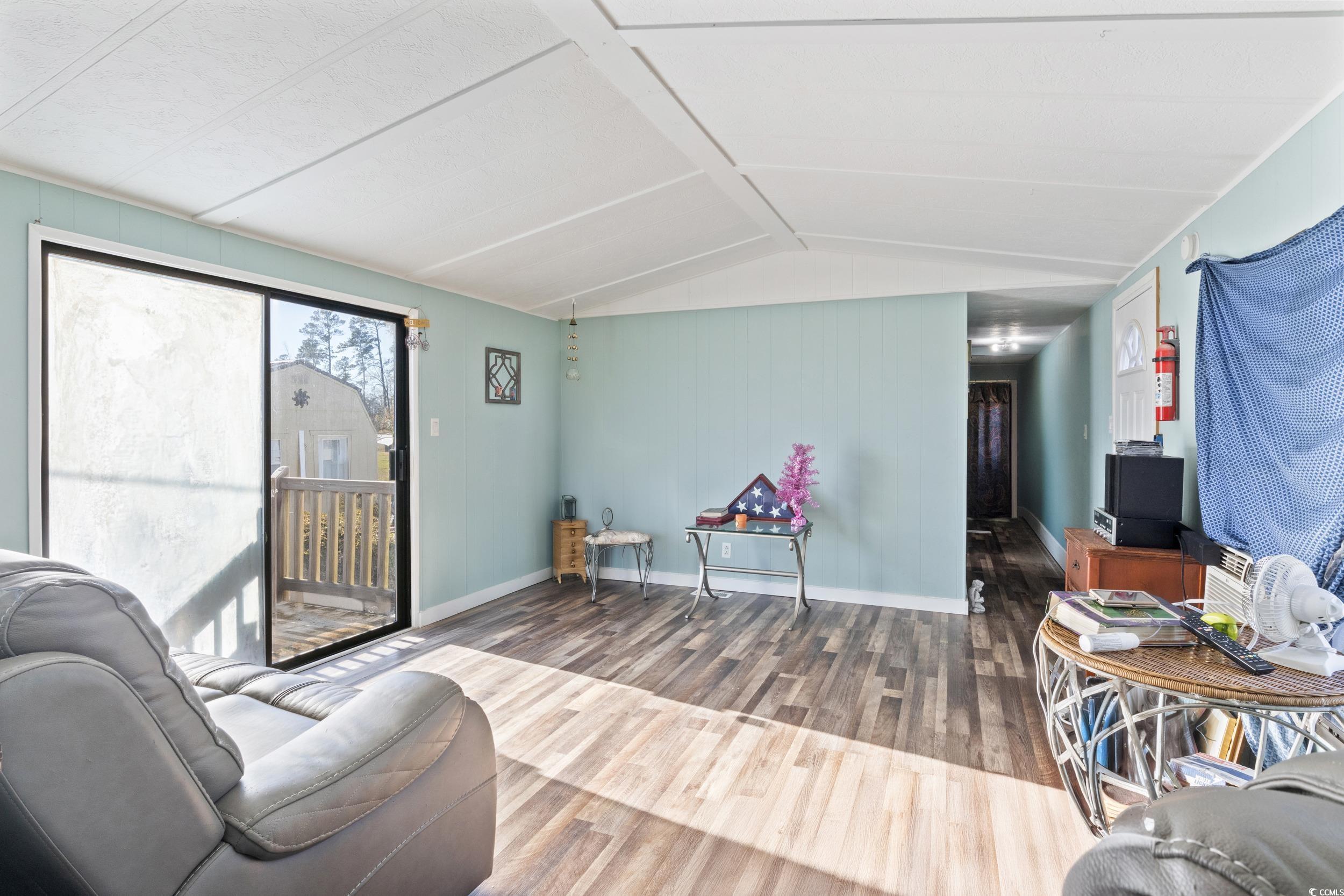 6469 Norton Road Green Sea, SC 29545 - Photo 4 of 25 Living room with wood-type flooring and vaulted ce