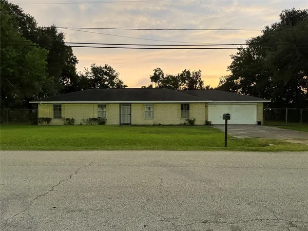 a view of backyard with wooden fence