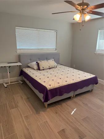 a bedroom with a bed and window